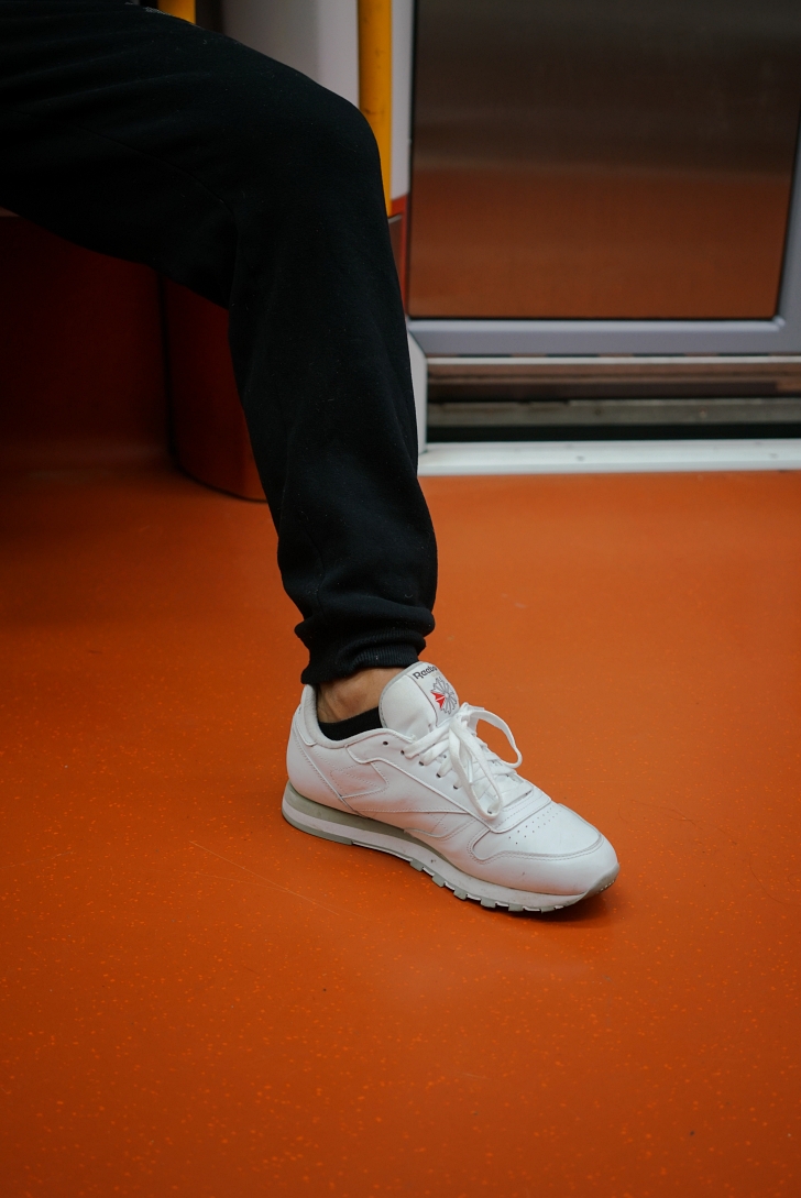 old school reebok sneakers being worn on a train