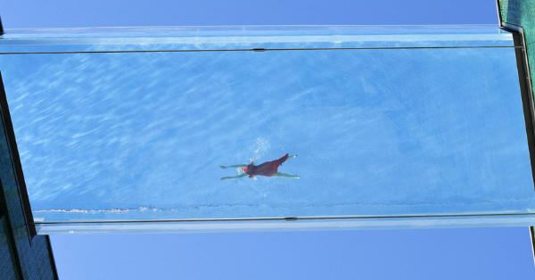 World’s First ‘Floating’ Pool Suspends 100 Feet Above The Ground