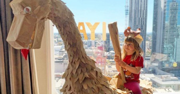 Family Uses Take-Out Containers To Build A Giant Dinosaur During A Hotel Quarantine