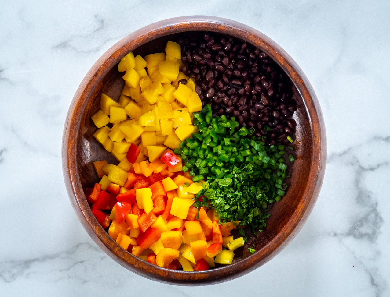 a bowl with separated ingredients for salad.