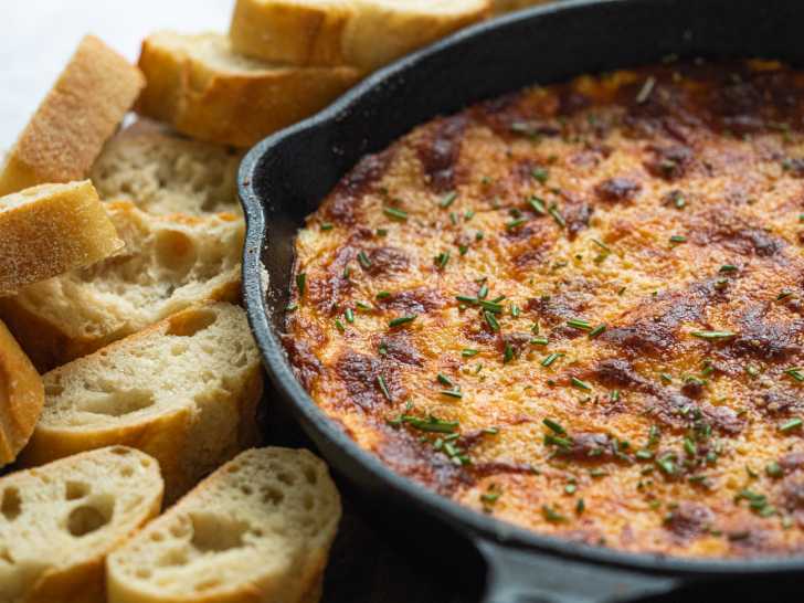 Baked cheese in a skillet surrounded by chips