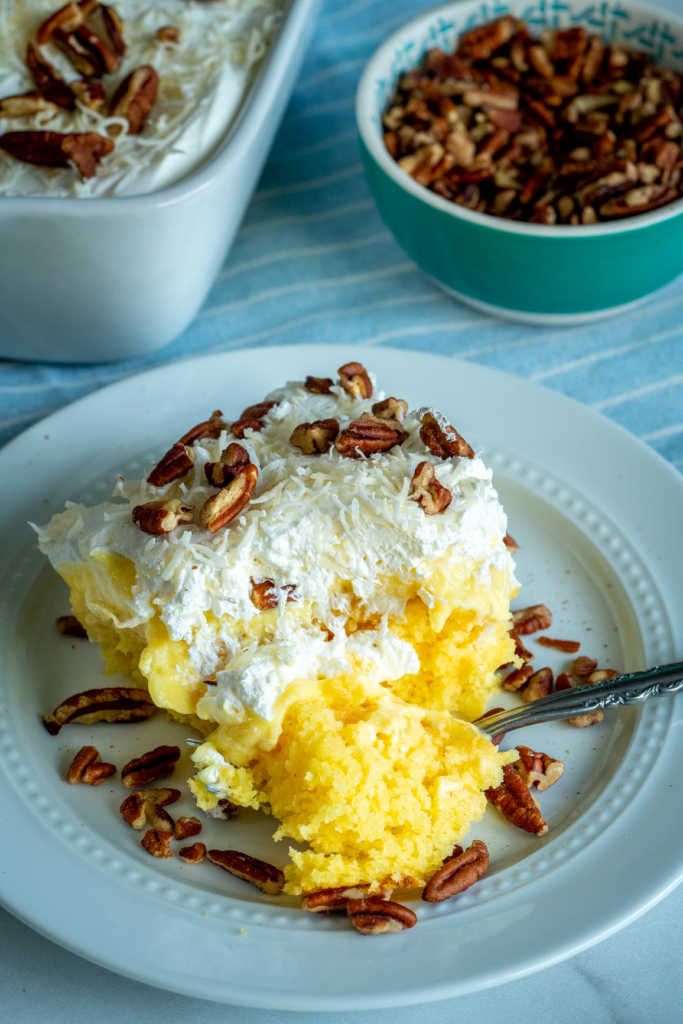 pineapple cake with Cool Whip frosting on a plate