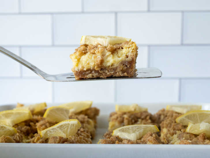 Lemon bar being lifted from pan