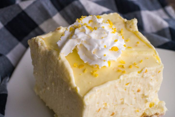 Single lemon cheesecake bar on a plate