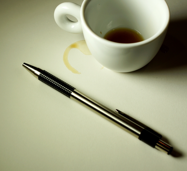 coffee cup with coffee ring on white table