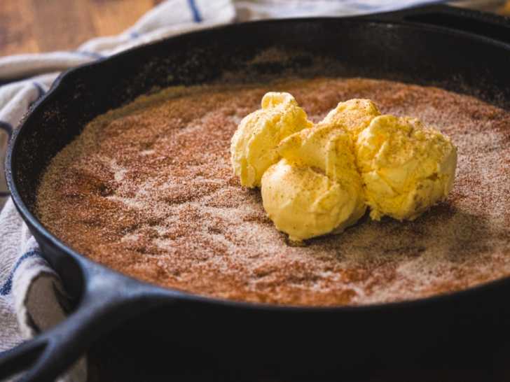 Close up of cake in a skillet with ice cream on top