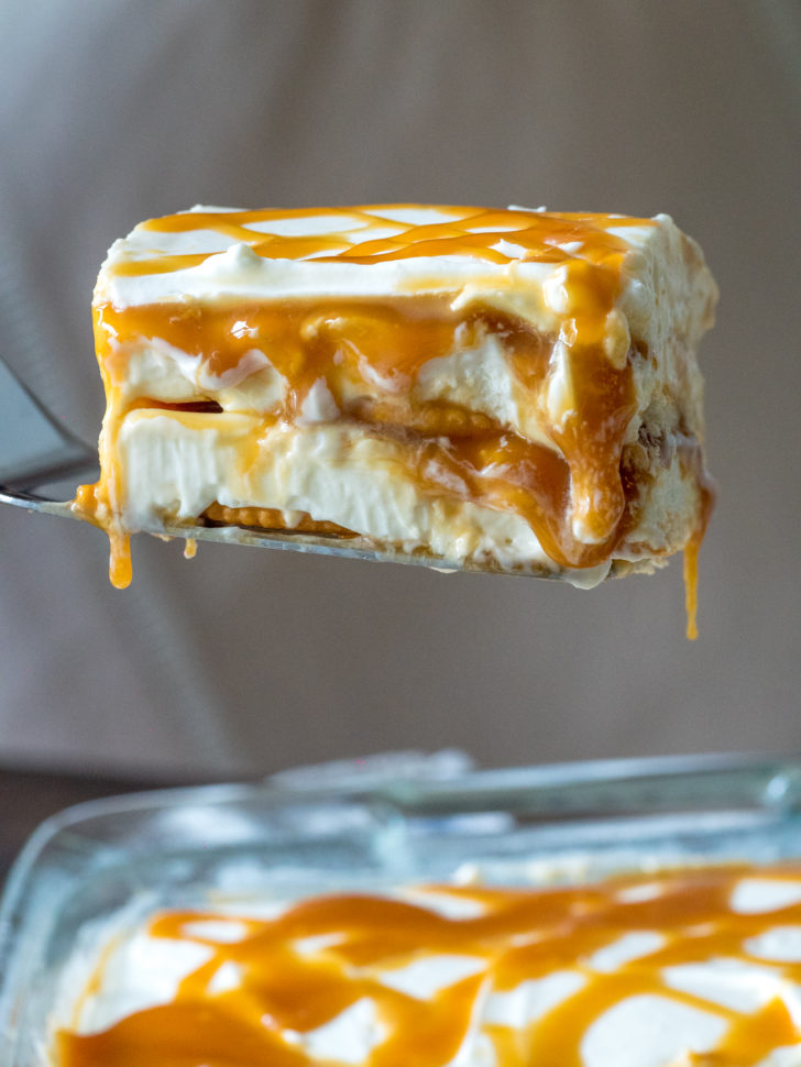A slice of caramel icebox cake being lifted out of the pan