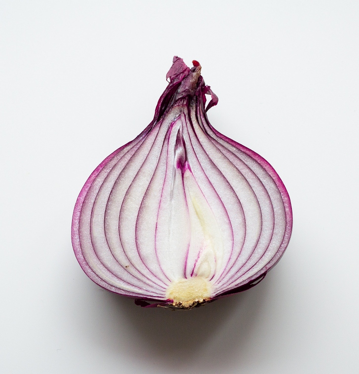 sliced red onion on white background
