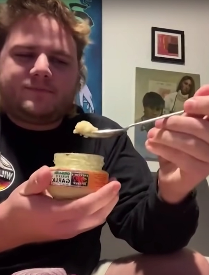 man tasting raw garlic paste