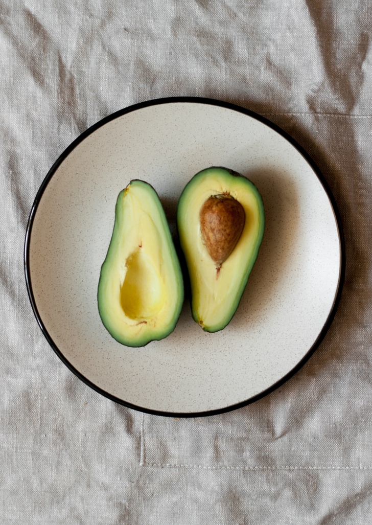 halved avocado on a plate