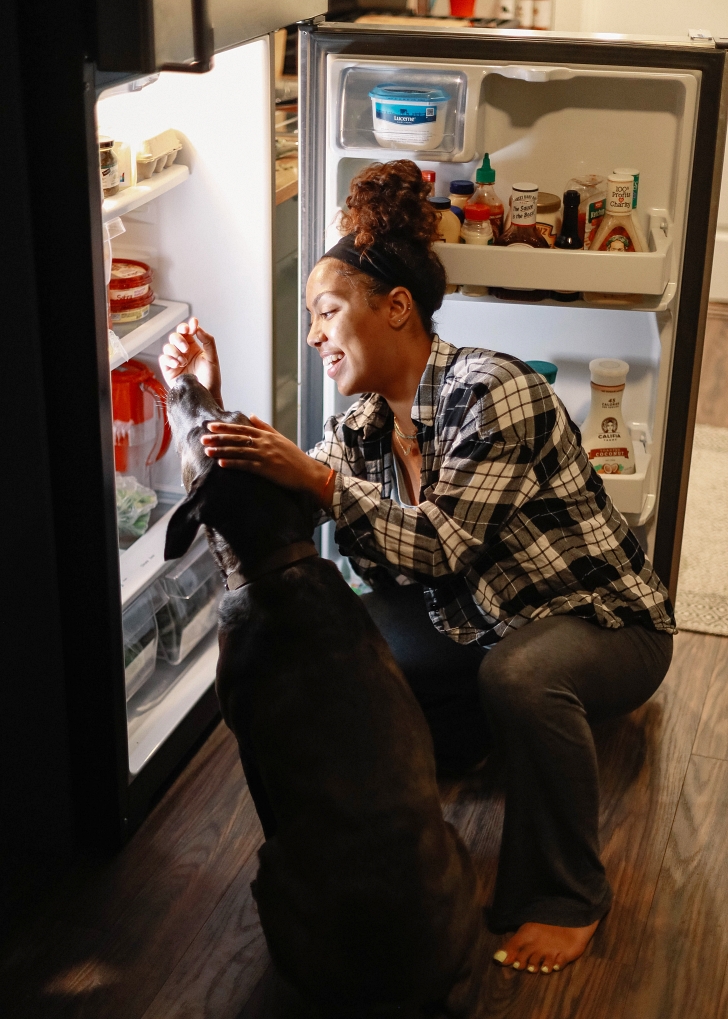 woman looking into her fridge