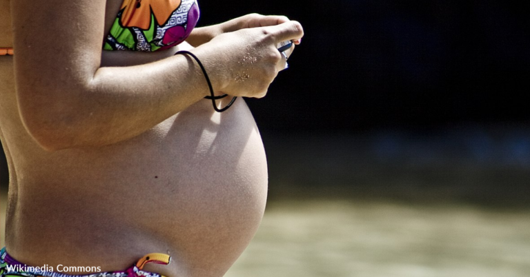 Man Digs Hole In The Sand So Pregnant Wife Can Sunbath With Her Bump