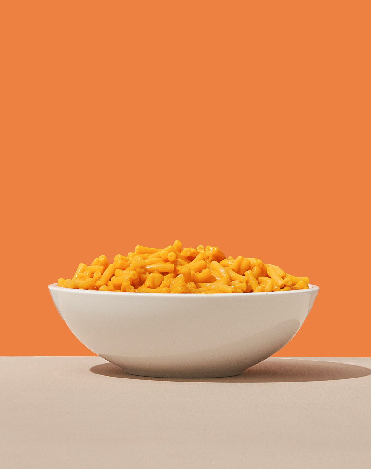 mac and cheese on orange background