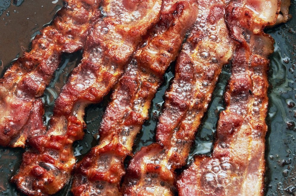 crispy bacon frying in pan