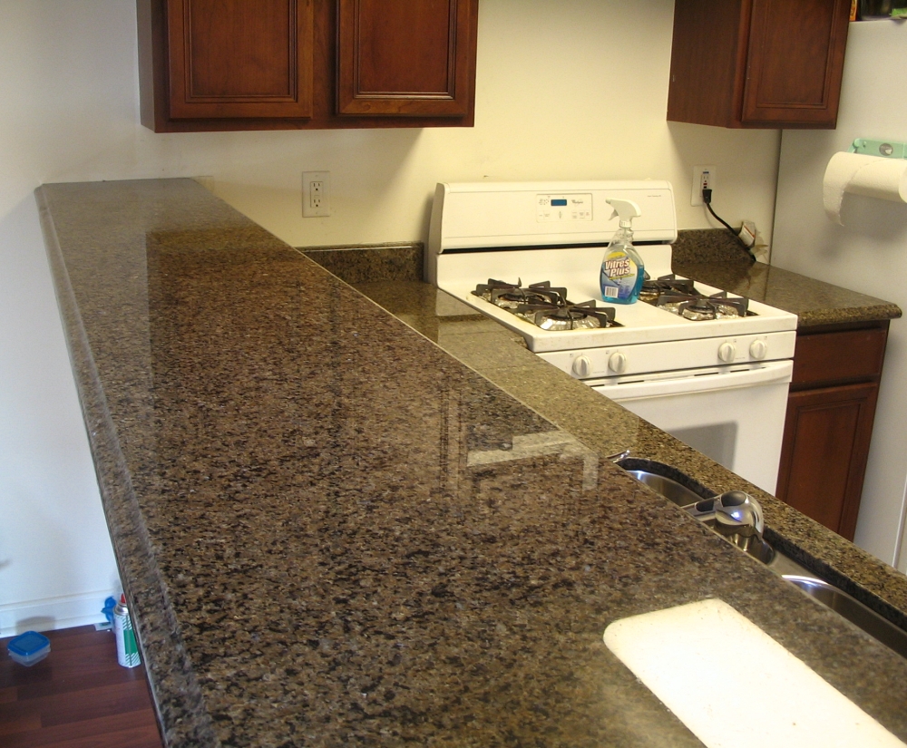 clean kitchen with bottle of window cleaner in background