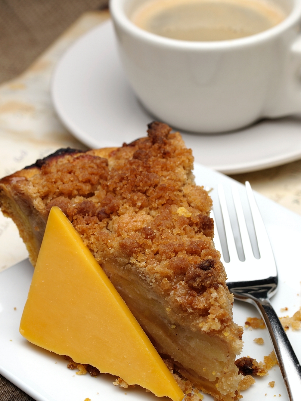 apple pie with a wedge of cheddar cheese