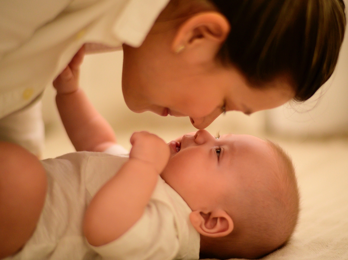 woman touching noses with a baby