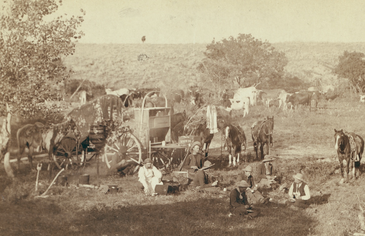1880s cowboys taking a break to eat by the mess wagon