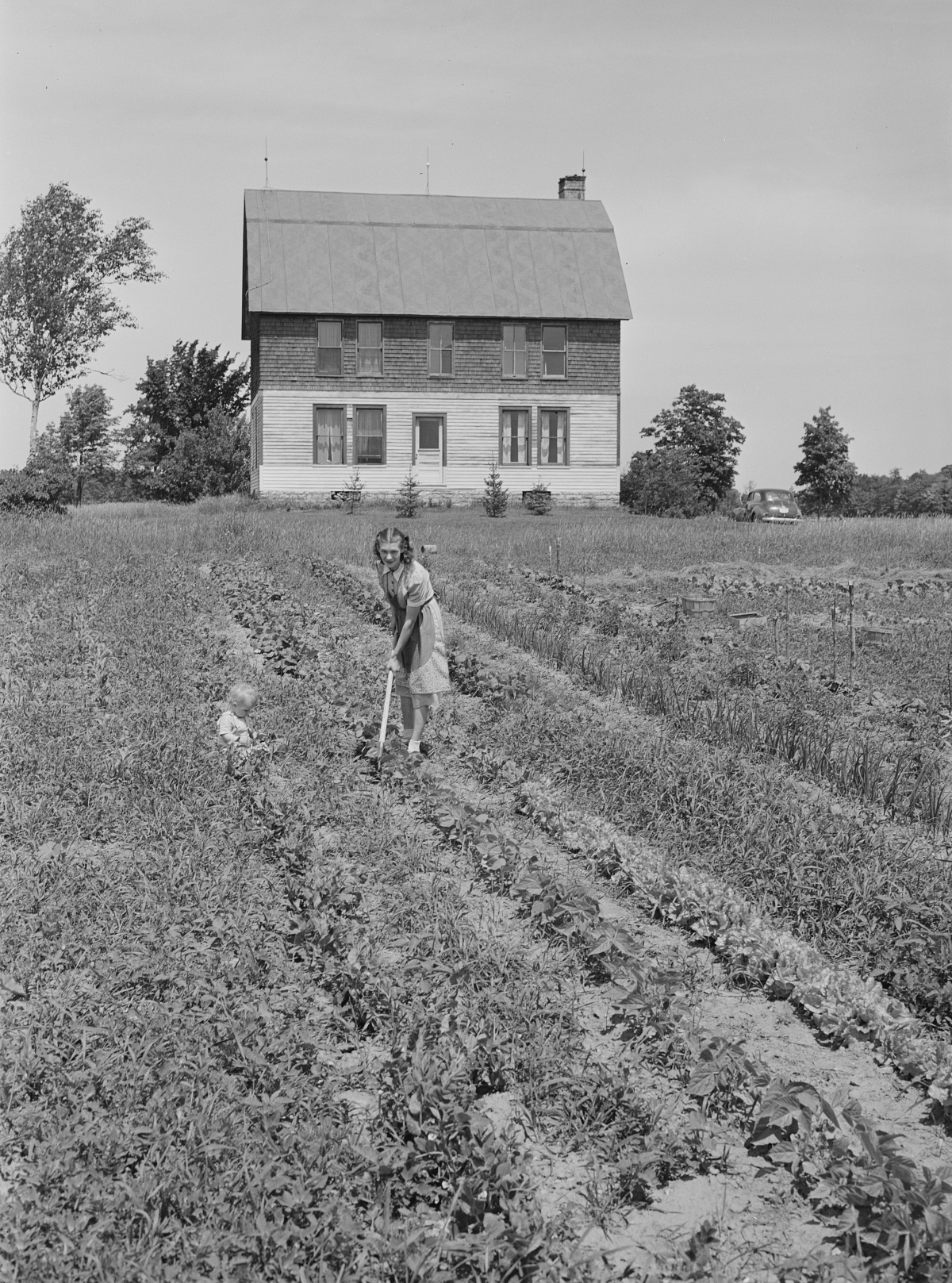 WWII era woman gardening on a farm