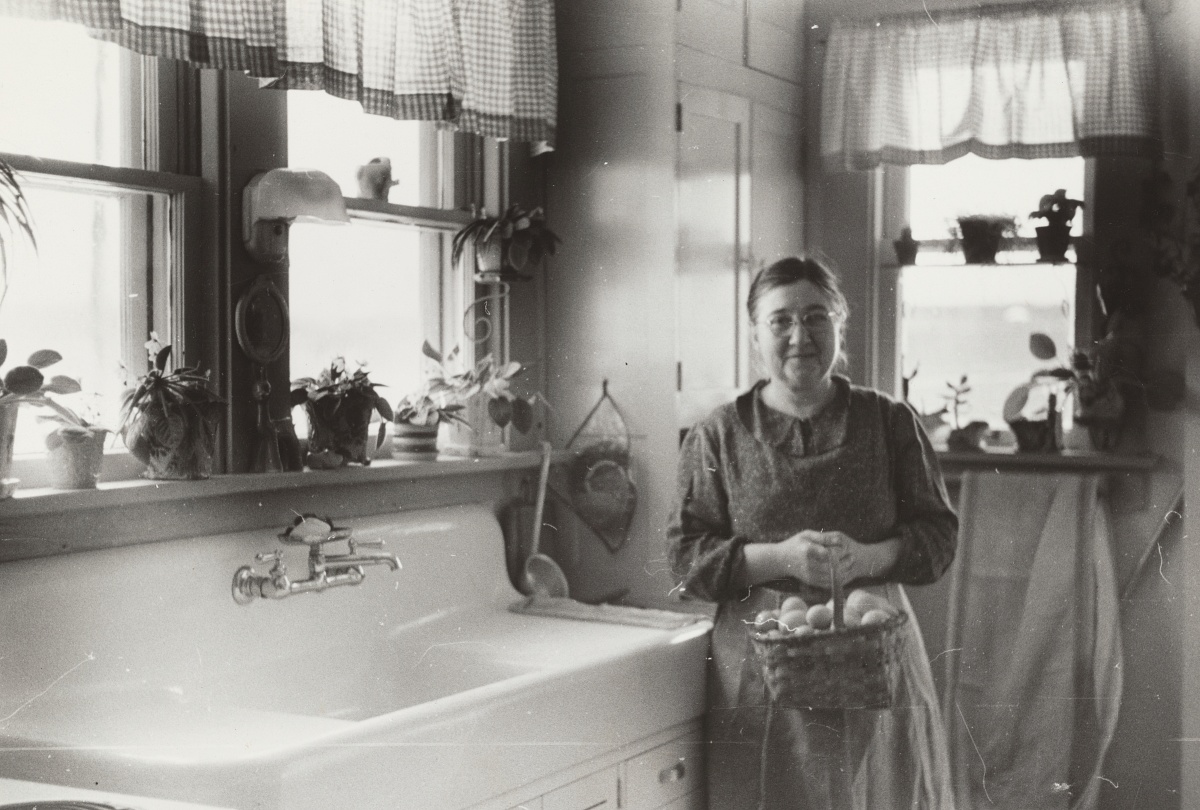 Great Depression era woman with plants in kitchen