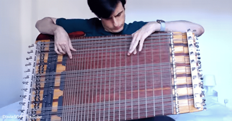 Musician Plays Solo On The Worlds’ Only 69 String Bass Guitar