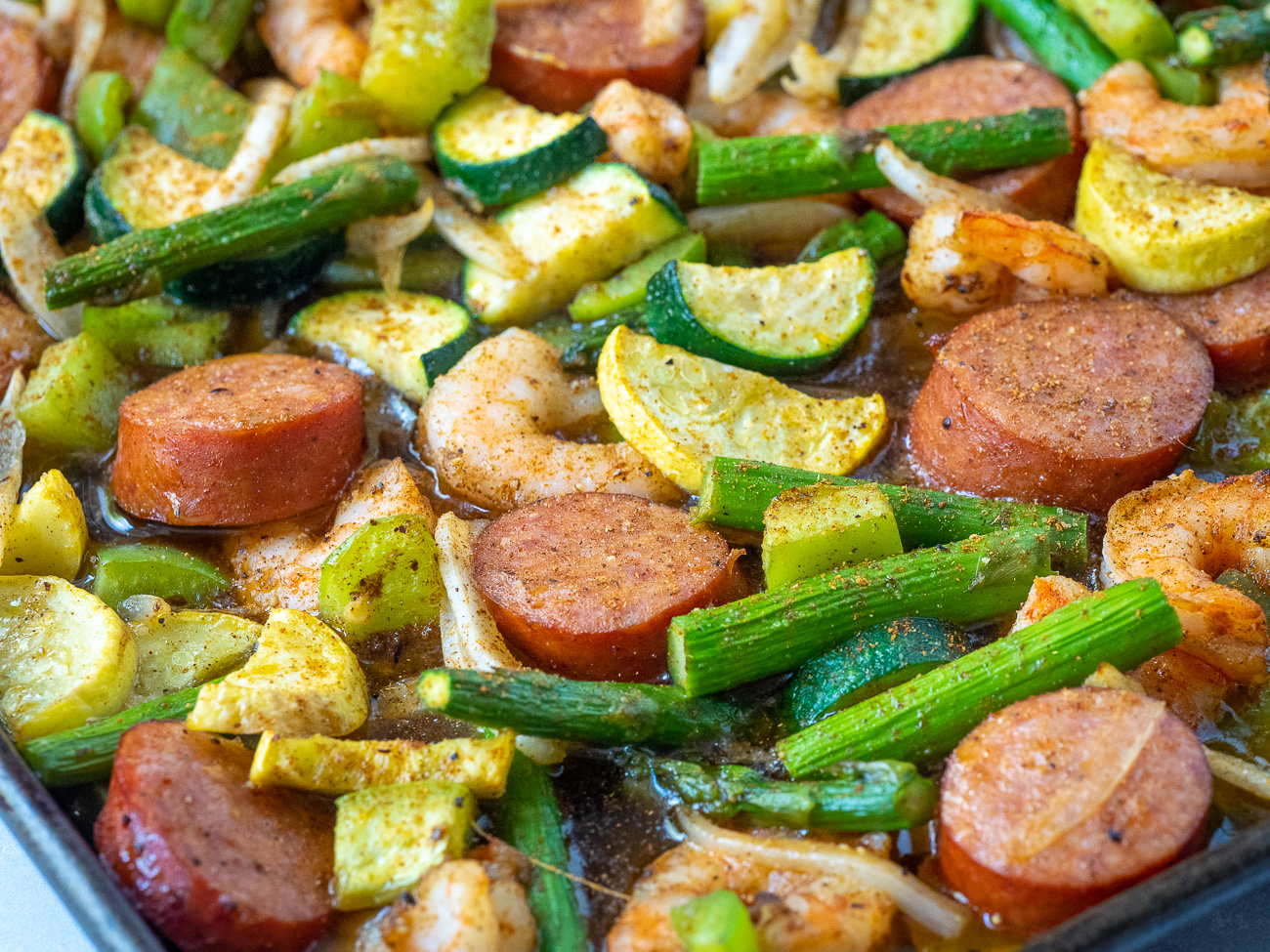 Sheet Pan Sausage & Veggies with Cajun Butter Sauce · Easy Family