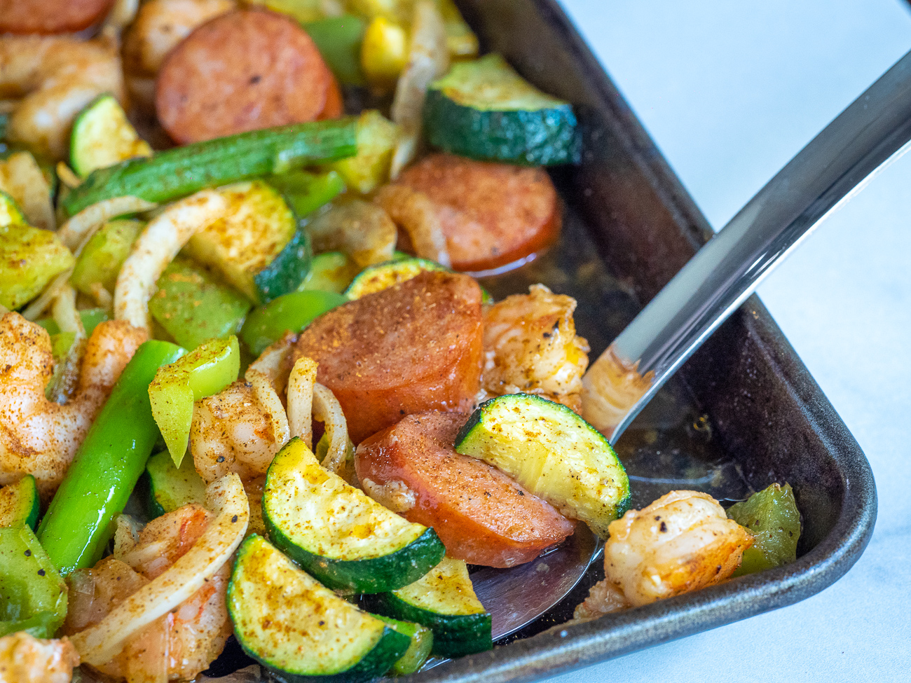 Sheet Pan Sausage & Veggies with Cajun Butter Sauce · Easy Family