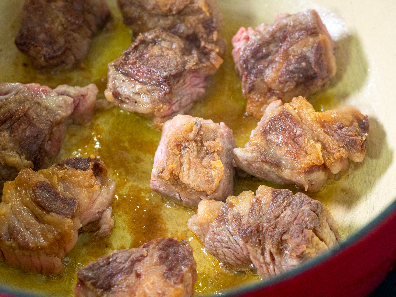 Combine salt, pepper, and flour in a large bowl. Toss beef with flour mixture. Heat 2 teaspoons oil in oven-safe stockpot over medium heat. Add beef and cook until browned on the outside and just beginning to caramelize. Remove beef from pan.
