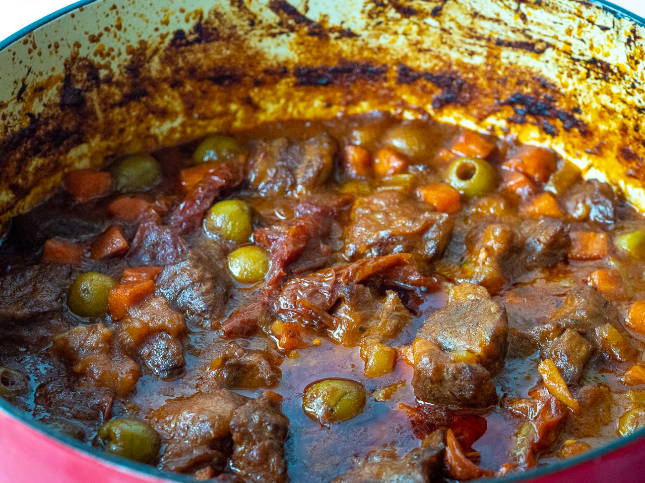 Add beef back to pan along with broth and olives. Cook for 4 minutes, then cover and place pan in oven for 2 hours. Check on progress every 20 minutes, adding more broth if stew becomes dry.