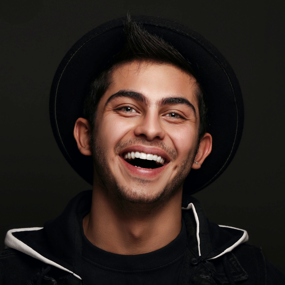 person smiling and wearing hat