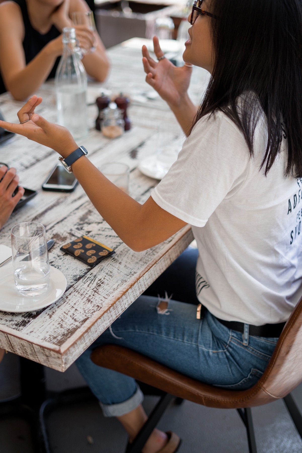 woman gesturing at restaurant table