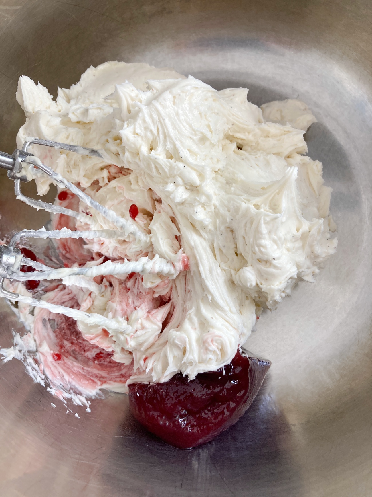 Using electric mixer incorporate 1/4 cup raspberry preserves into frosting. If desired reserve some plain frosting before mixing raspberry in to create 2 colors of icing to decorate with.