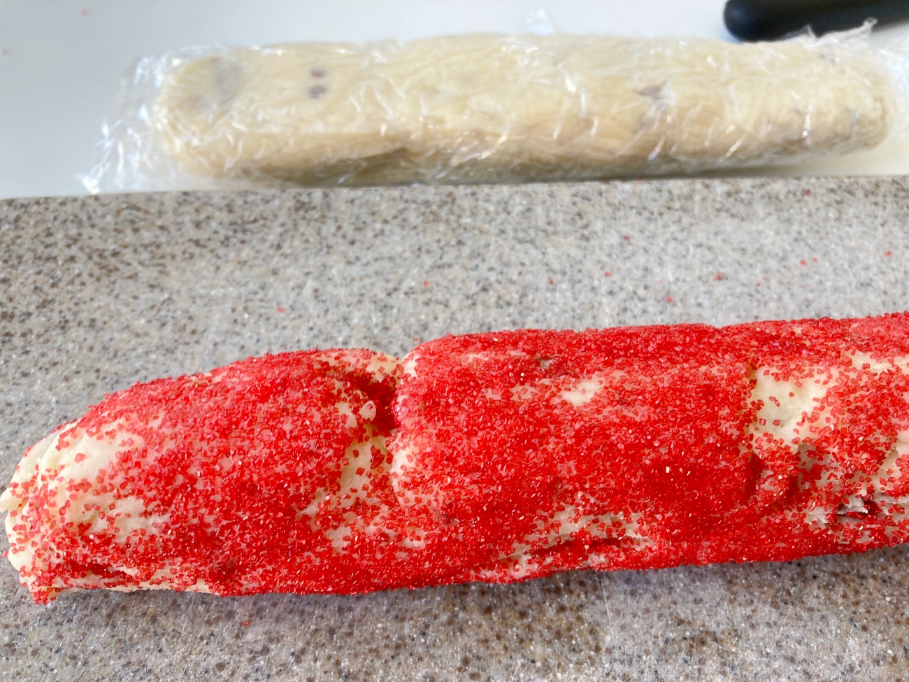 Preheat oven to 325˚F. Place red crystals on a plate or tray, and green sugar on a separate plate. Roll 2 logs in red sugar and remaining logs in green sugar. Using a very sharp knife cut each log into slices 1/4