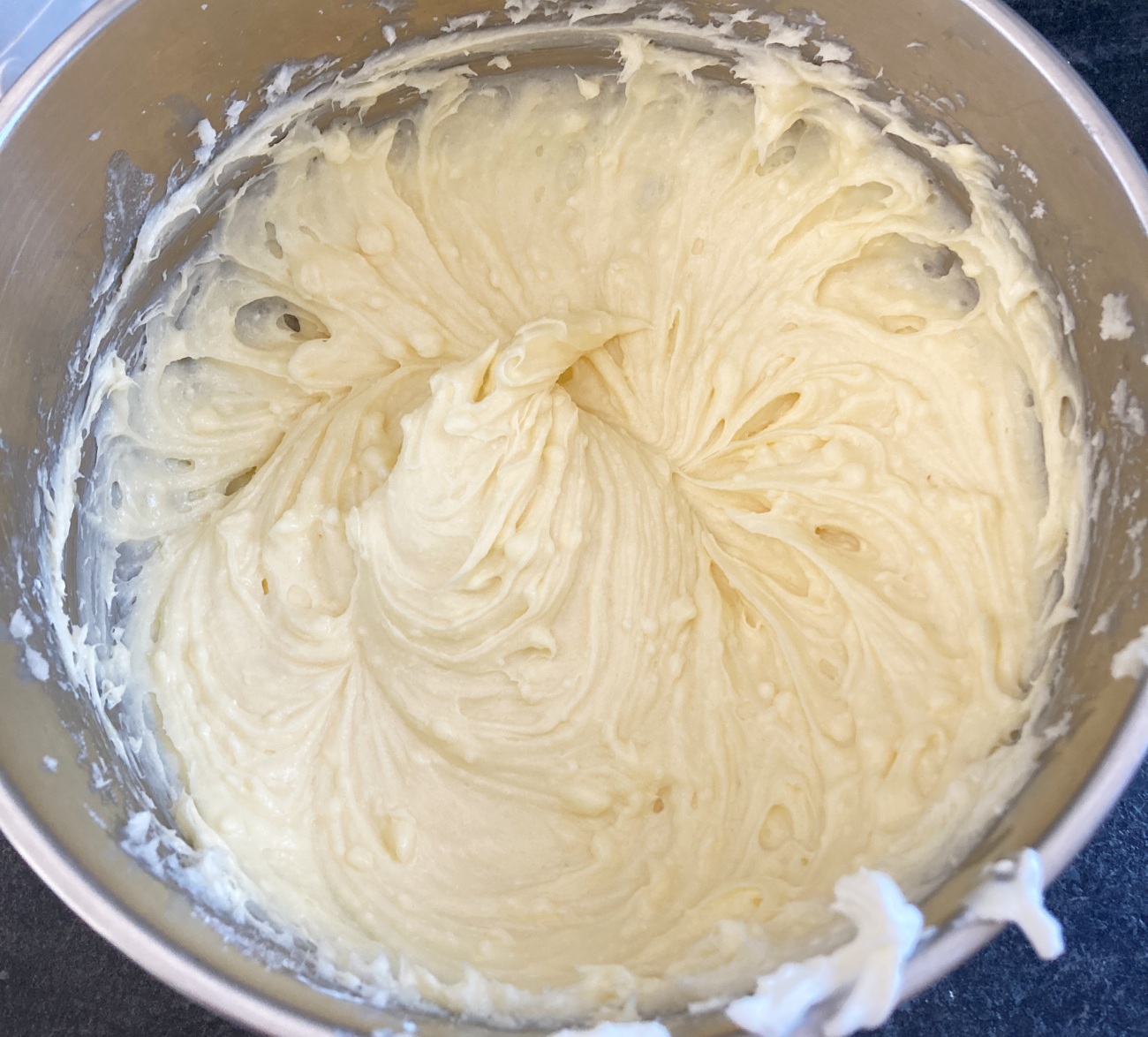 Cream together butter, cream cheese, and sugar. Add in egg and vanilla and stir well. Add 1 cup of flour to wet ingredients at a time, stirring each time. Then add salt and stir. Fold in chopped pecans.