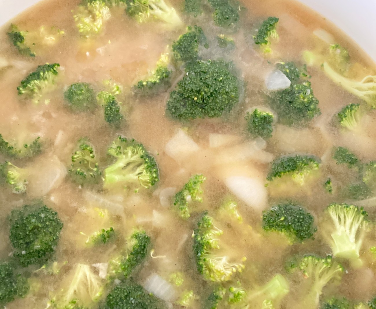 Add broth and first half of chopped broccoli to pan. Raise heat to high until boiling then reduce heat to medium-low and simmer for 8-10 minutes.