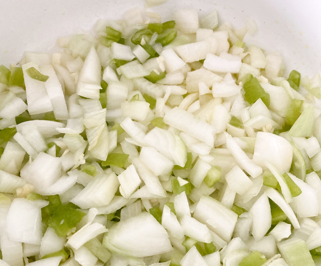 Heat oil in large stockpot over medium heat. Add onions, pepper, and garlic to pan. Cook for 5 minutes and stir often.