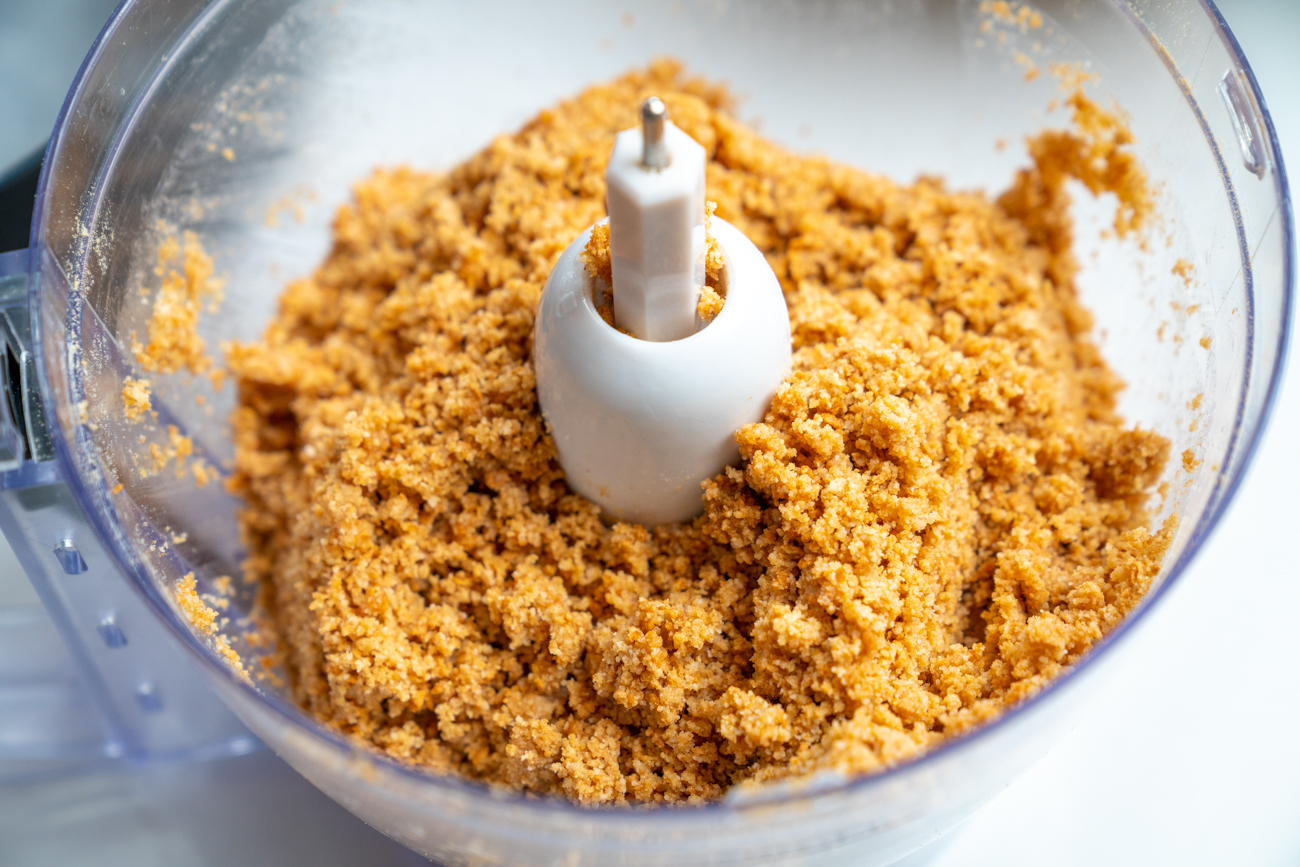 Preheat oven to 350˚F. Combine graham cracker crumbs, almond flour, powdered sugar, and 1/2 cup of browned butter in food processor and pulse until sandy mixture forms. Add to bottom and sides of a deep 8