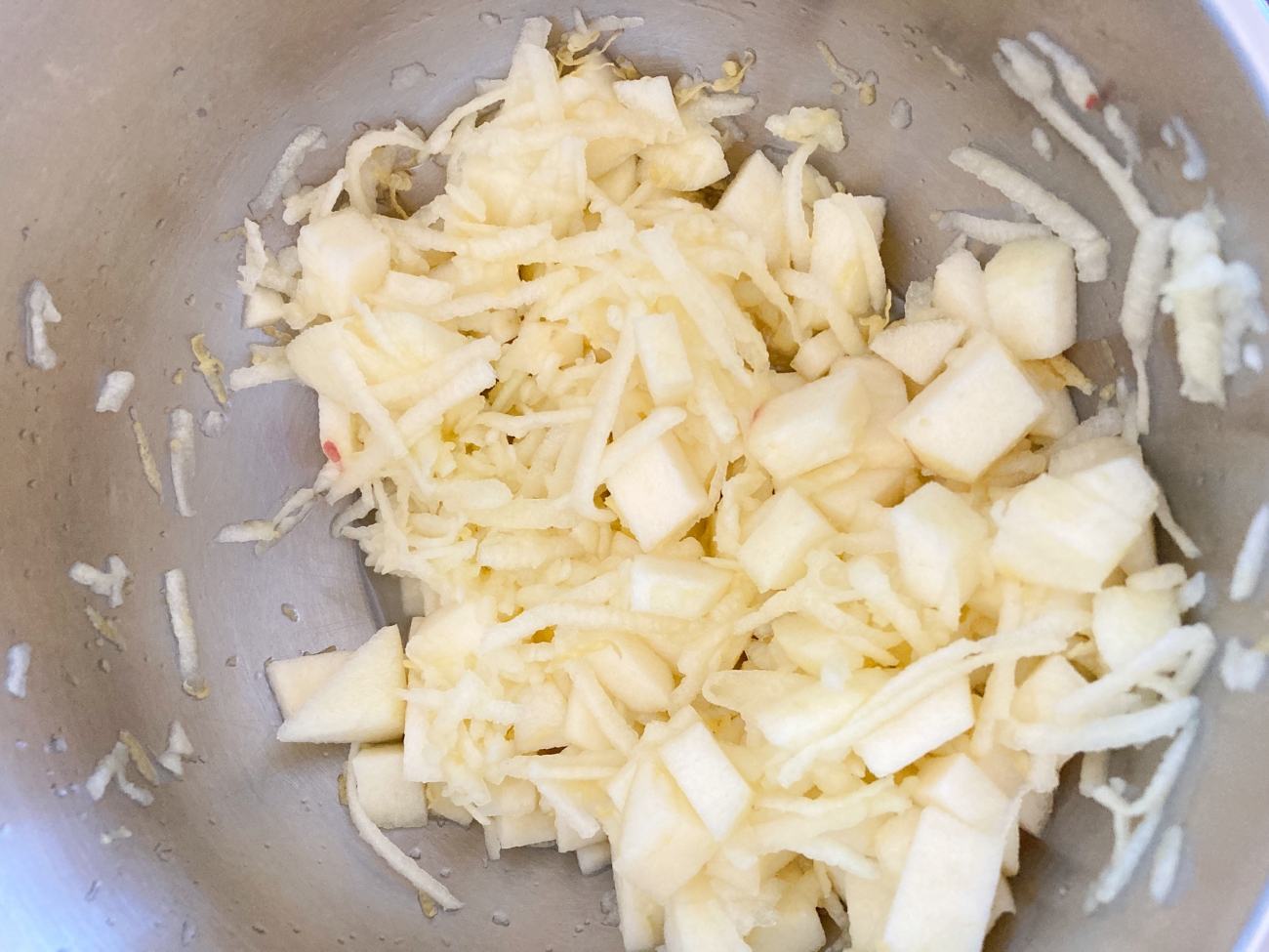 Preheat oven to 350˚F. Peel and dice 1 apple. Peel and grate the other apple. Place in large bowl and toss with lemon juice and zest.