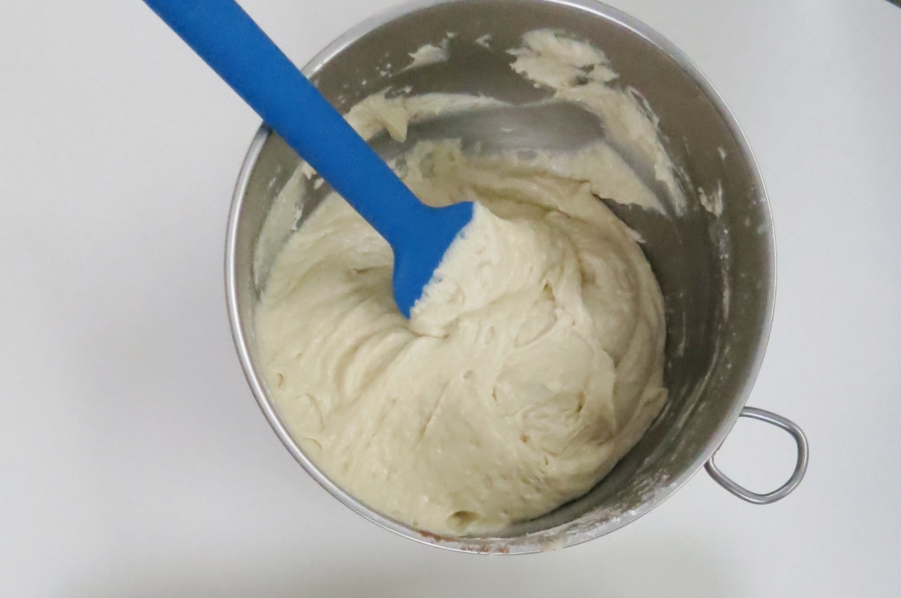 In a large bowl combine remaining sugar with butter until lightened. Add eggs and vanilla and mix again. Stir in milk. Add in flour, baking powder, and salt. Mix until uniform in color.