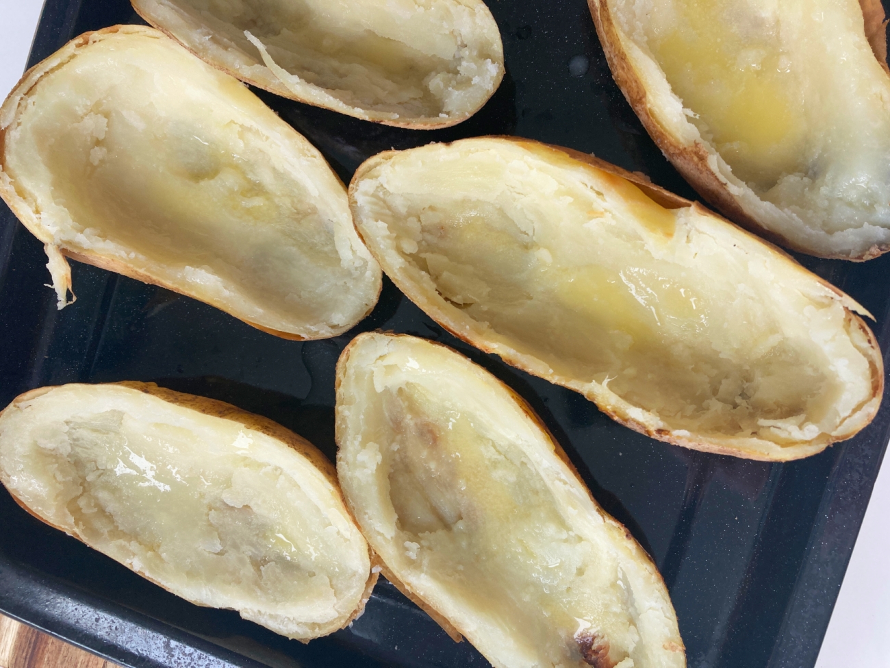 Brush outside and inside of potato skins with remaining butter. Place on baking pan and bake for 10 minutes at 400˚F. Flip skins then bake another 10 minutes. While skins bake prepare gravy to package directions.