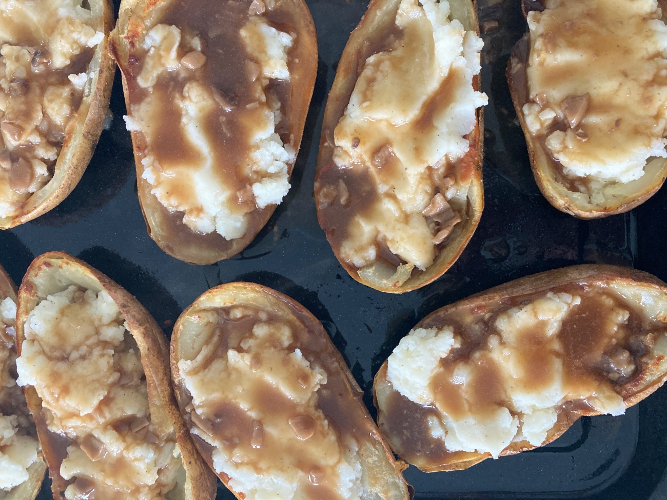 Spoon filling back into potato skins. Top with gravy and curds and reserve extra gravy. Return to oven for 5-8 minutes or until curds have begun to melt.