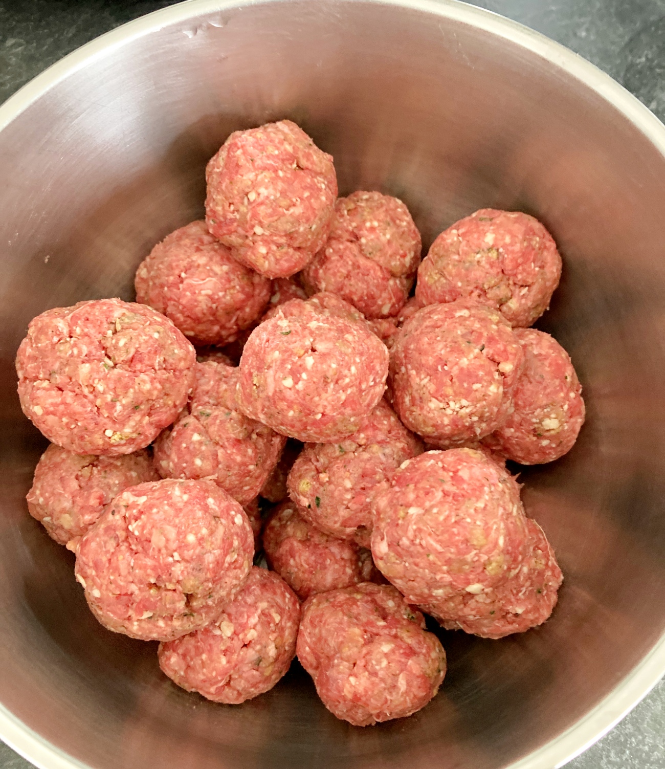 Combine beef with egg, breadcrumbs, Italian seasoning, onion powder, parmesan cheese, and parsley. Roll into balls 1” to 1 ½” across and set aside.