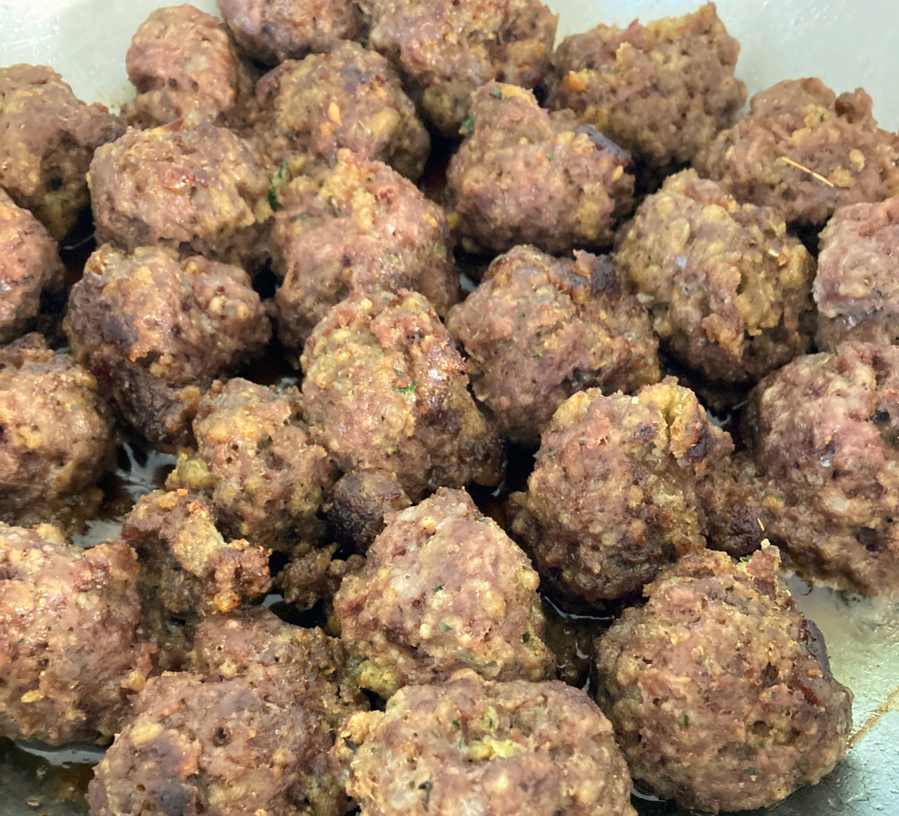Preheat oven to 450˚F. Add 1 tablespoon oil and meatballs to pan. Cook for 5-6 minutes each side until browned.
