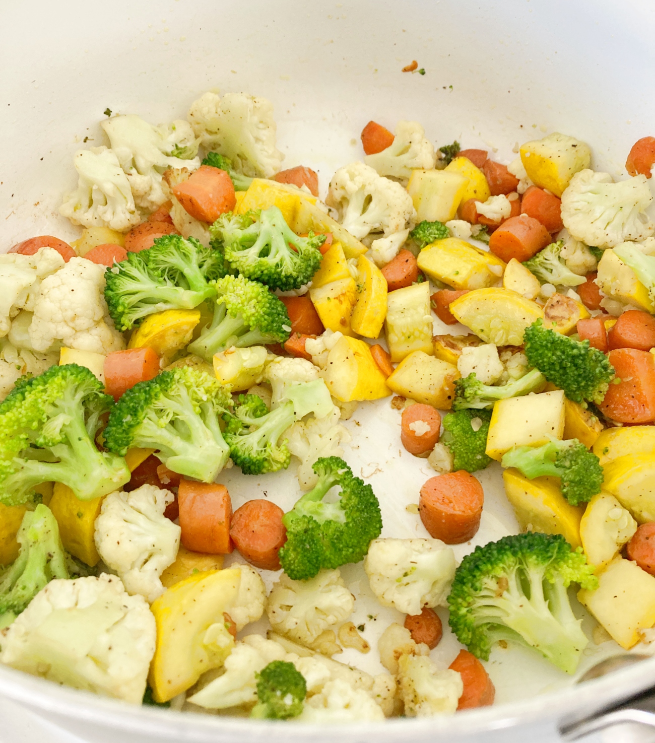 Heat 1 tablespoon olive oil in stockpot on medium heat. Add carrots, cauliflower, and broccoli, squash to pan. Cook for 5-7 minutes or until softened. Stir in salt and pepper and remove from pan for later. Wipe out hot pan with paper towel and some tongs.