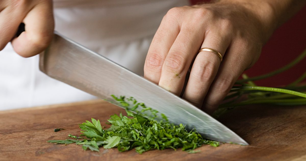Chef chopping parsley