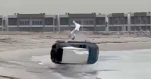 Still of the flipping vehicle with the driver in mid- air.