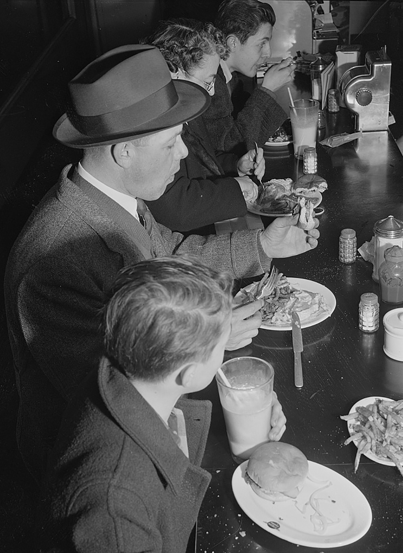 people eating at a lunch counter in 1943