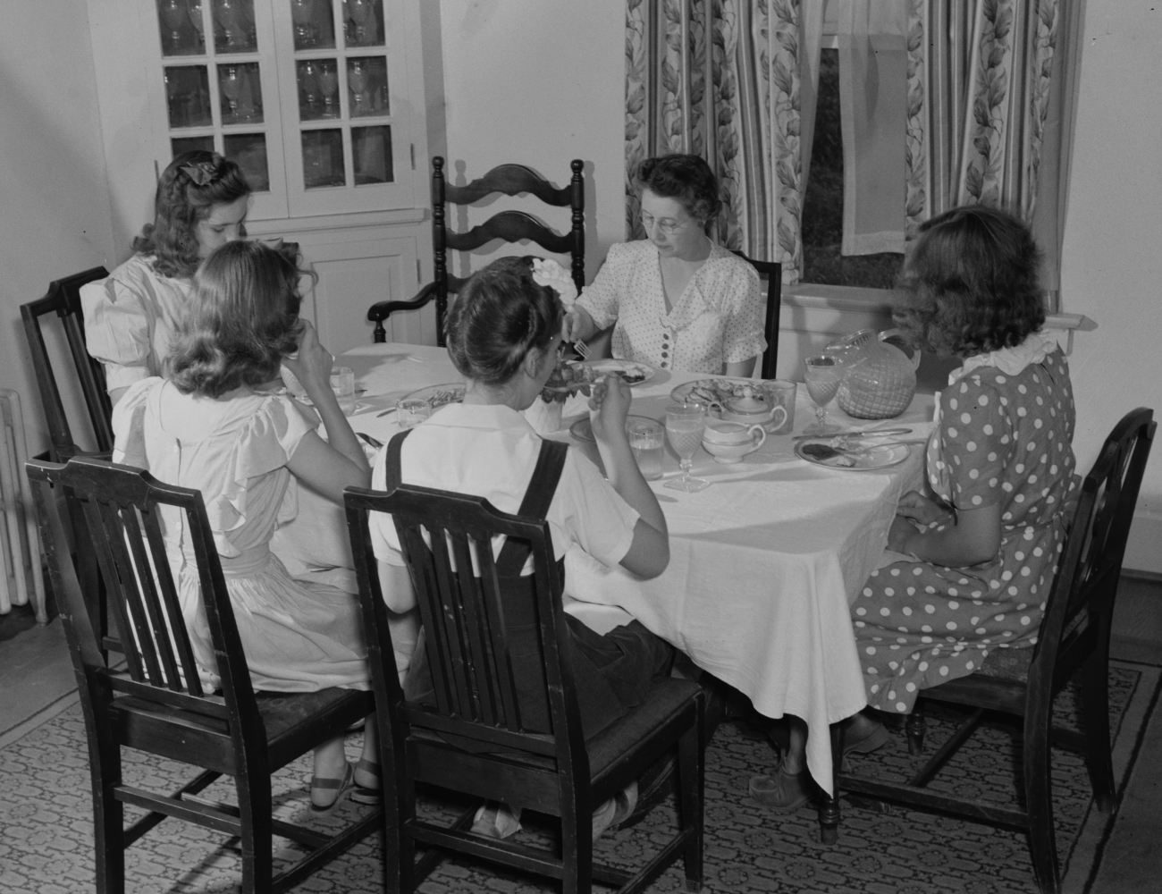 Girls Gathered Around Dinner Table