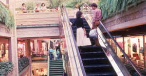 escalators in a bustling mall in the 1980s