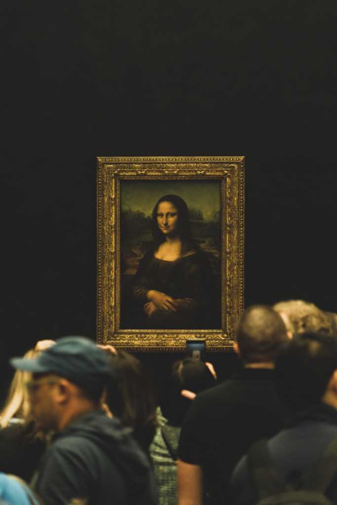 the Mona Lisa surrounded by visitors to the Louvre